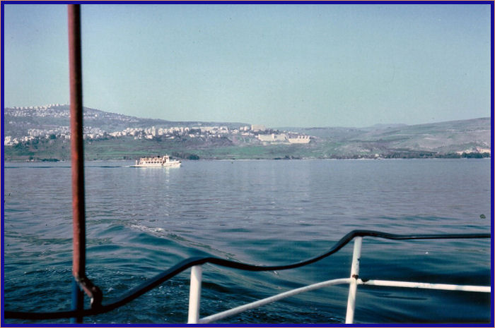 Another tour boat with Tiberias in the distance